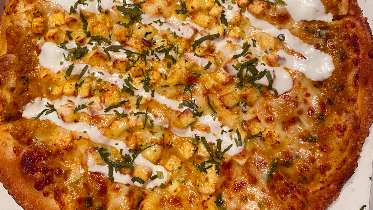 Indian fusion pizza topped with paneer tikka masala at Bombay Pizza Kitchen in Eden Prairie, MN.