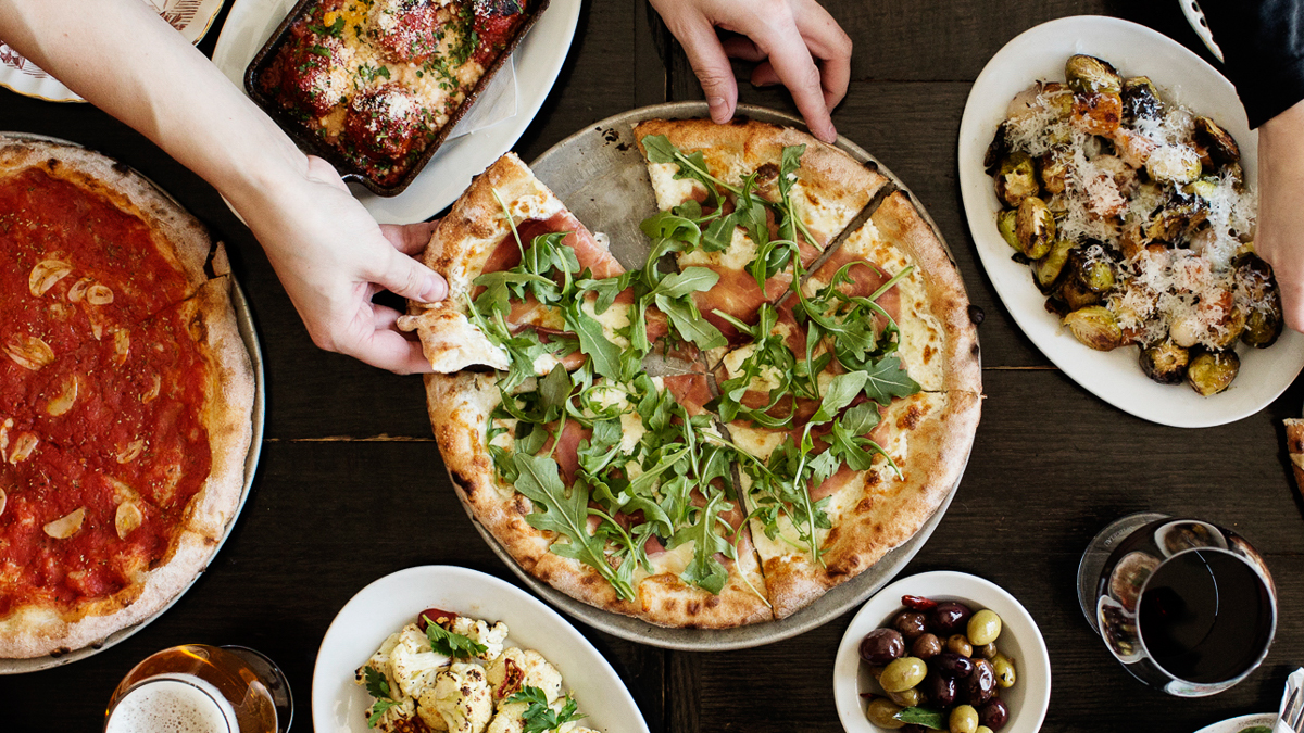 Neapolitan style pizza topped with greens, arugula, and cheese in Edina, MN.